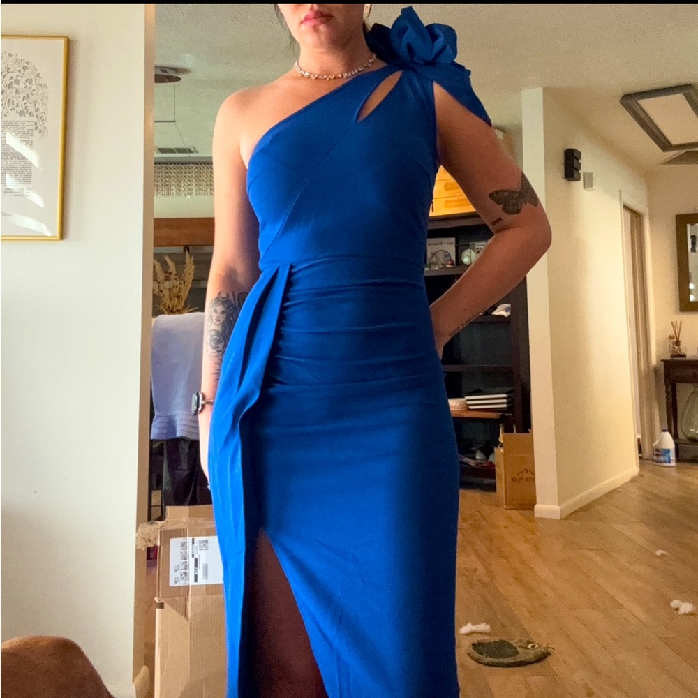 Long blue dress with flower detail on shoulder